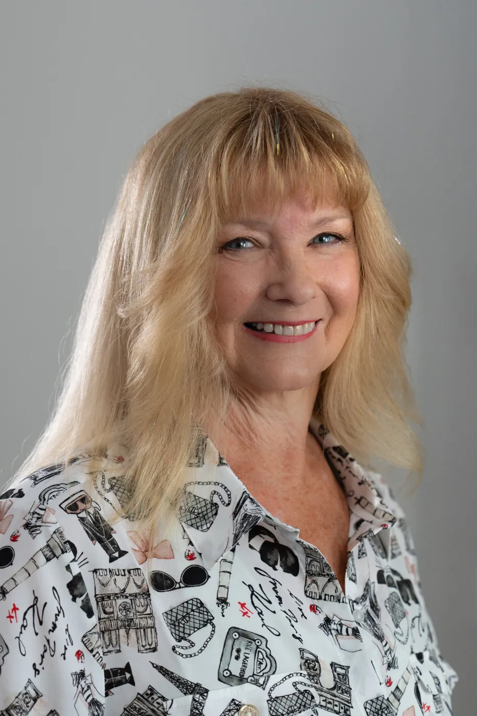 Headshot of a smiling woman with blonde hair